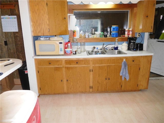 kitchen with light wood-type flooring and sink