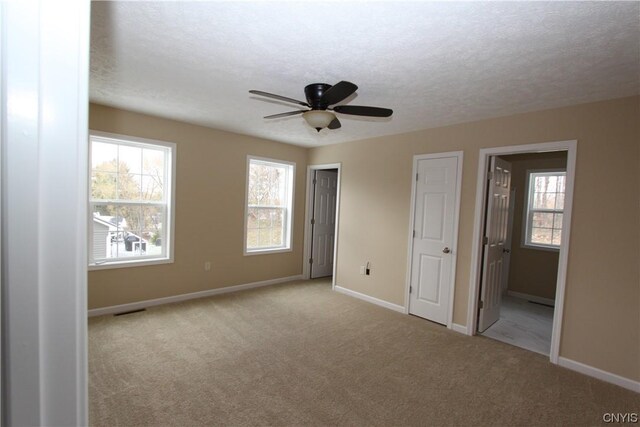LOT214 Tall Tree Ln, Lysander, NY 13027 - unfurnished bedroom featuring baseboards, multiple windows, visible vents, and carpet