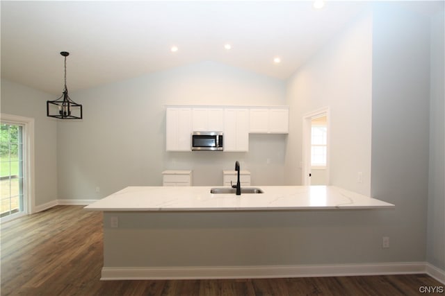 kitchen featuring white cabinets, light stone countertops, dark hardwood / wood-style floors, and sink