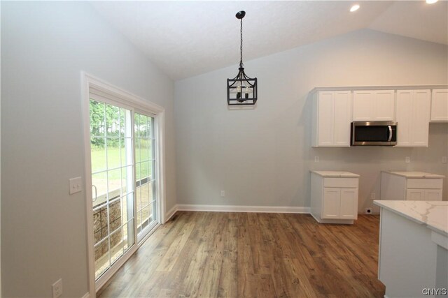 LOT214 Tall Tree Ln, Lysander, NY 13027 - kitchen featuring stainless steel microwave, vaulted ceiling, wood finished floors, and white cabinets