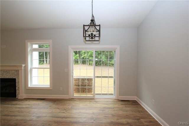 LOT214 Tall Tree Ln, Lysander, NY 13027 - entryway featuring a high end fireplace, plenty of natural light, wood finished floors, and a notable chandelier