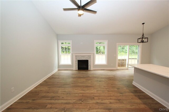 LOT214 Tall Tree Ln, Lysander, NY 13027 - unfurnished living room featuring lofted ceiling, dark wood-style floors, and ceiling fan with notable chandelier