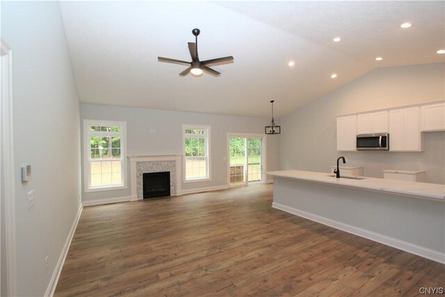 LOT214 Tall Tree Ln, Lysander, NY 13027 - kitchen featuring a sink, white cabinets, stainless steel microwave, lofted ceiling, and recessed lighting