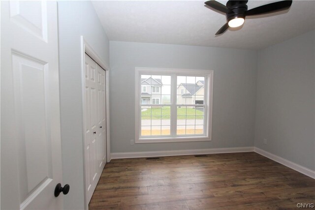 LOT214 Tall Tree Ln, Lysander, NY 13027 - unfurnished bedroom featuring baseboards, a closet, dark wood-style floors, and ceiling fan