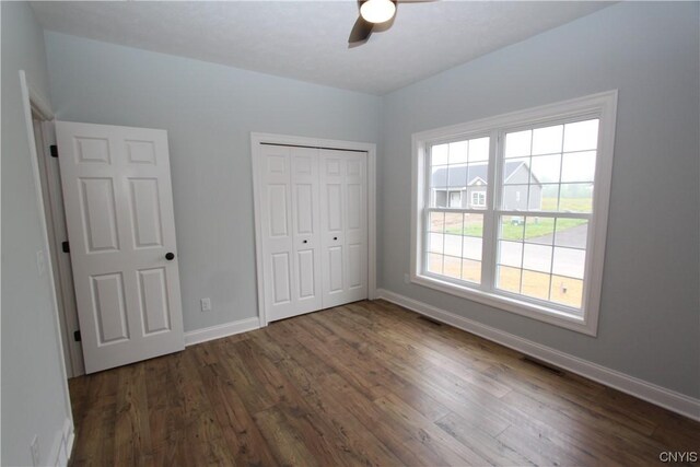 LOT214 Tall Tree Ln, Lysander, NY 13027 - unfurnished bedroom with visible vents, baseboards, dark wood-type flooring, and a closet