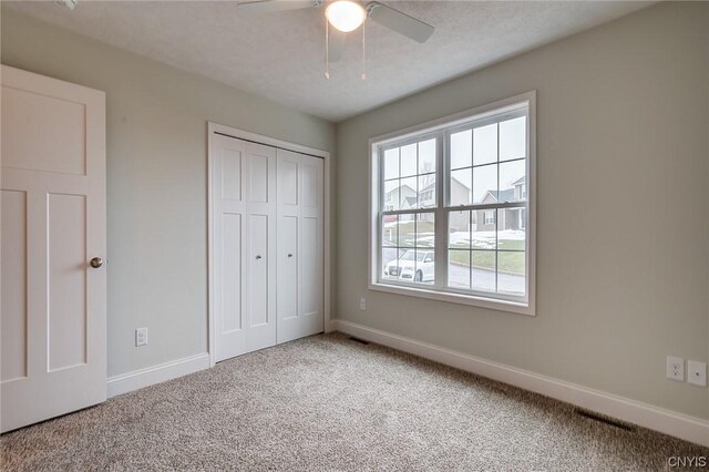 LOT214 Tall Tree Ln, Lysander, NY 13027 - unfurnished bedroom with visible vents, baseboards, a closet, ceiling fan, and carpet floors