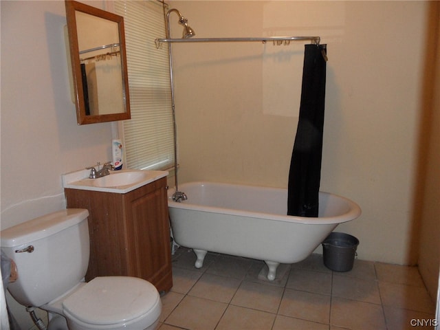 bathroom featuring toilet, tile floors, and vanity