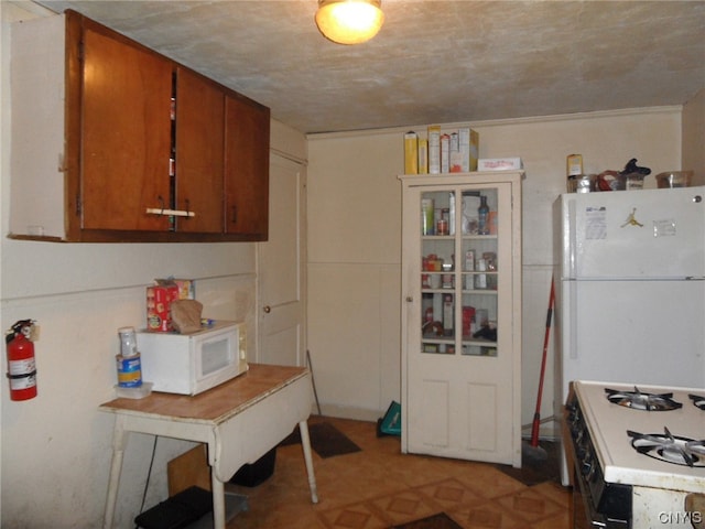 kitchen with white appliances and light parquet flooring