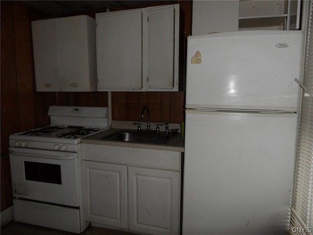 kitchen with white cabinets, white appliances, and sink