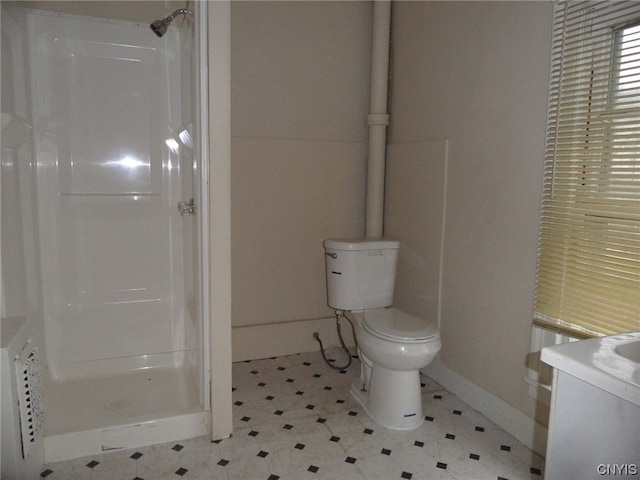 bathroom featuring a shower, tile flooring, toilet, and vanity