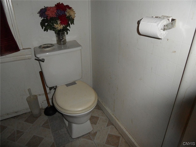 bathroom featuring tile floors and toilet