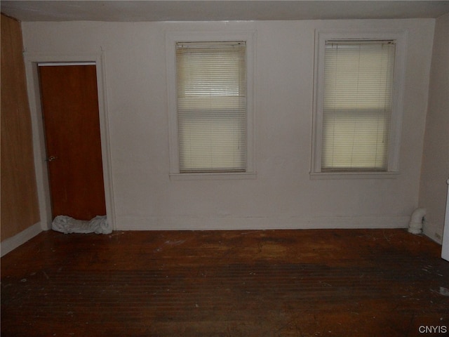 empty room with dark hardwood / wood-style flooring