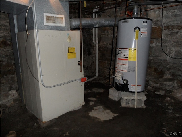 utility room featuring gas water heater and heating utilities