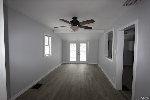 empty room featuring vaulted ceiling, ceiling fan, french doors, and dark hardwood / wood-style flooring