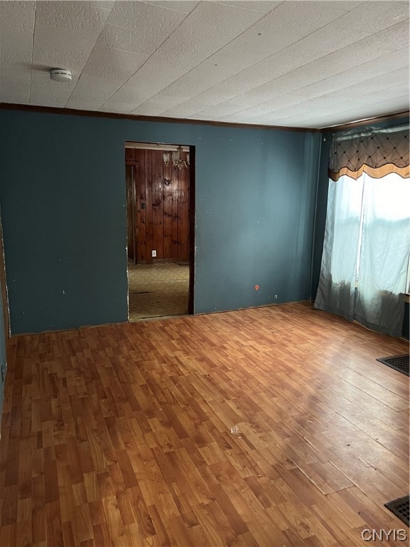 unfurnished room featuring hardwood / wood-style flooring