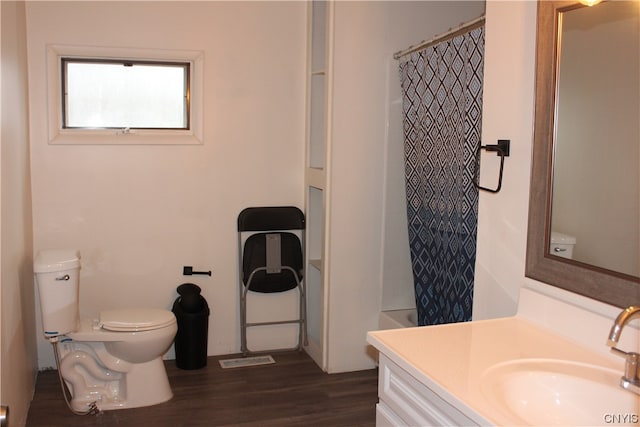 bathroom with hardwood / wood-style floors, vanity, and toilet