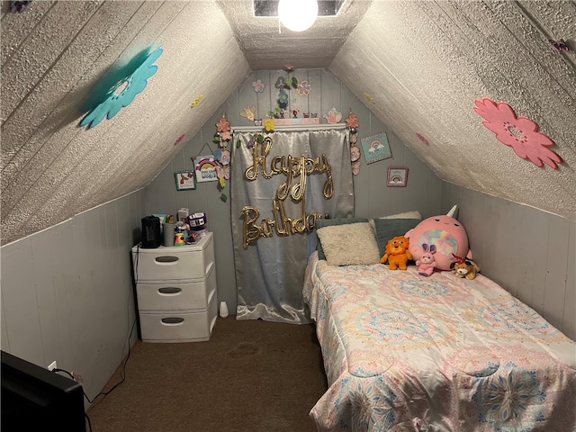 bedroom featuring carpet, vaulted ceiling, and a textured ceiling