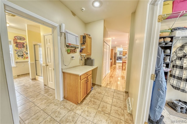 corridor featuring light tile floors