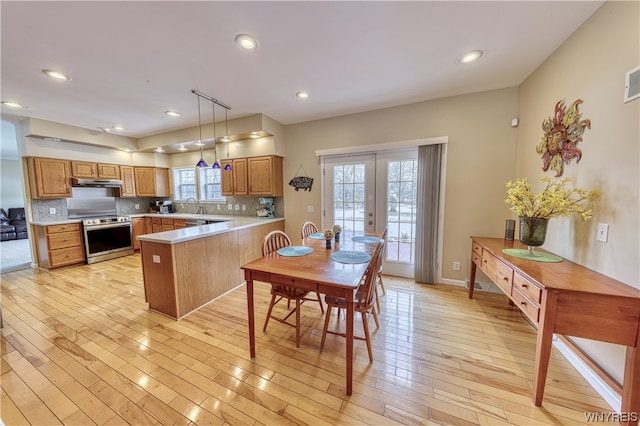 kitchen featuring tasteful backsplash, french doors, stainless steel electric range oven, kitchen peninsula, and hanging light fixtures