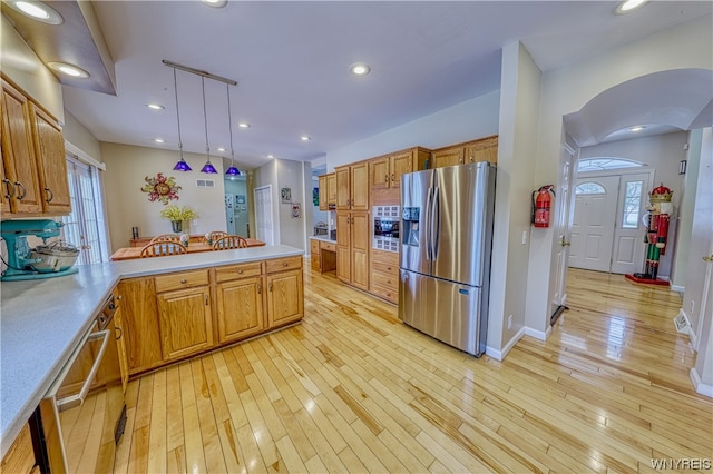 kitchen with light hardwood / wood-style flooring, pendant lighting, stainless steel appliances, and a healthy amount of sunlight