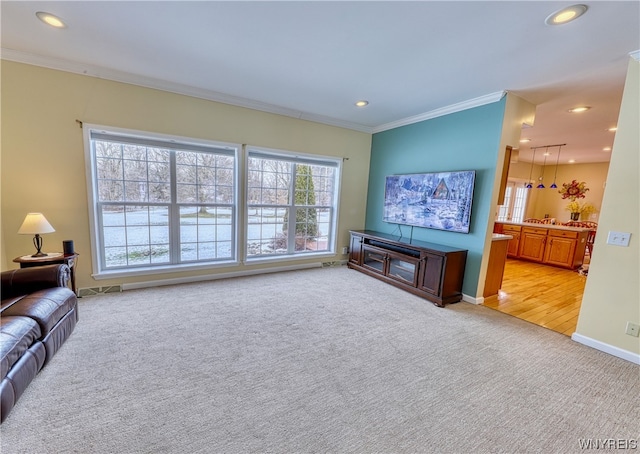 living room with ornamental molding and light carpet