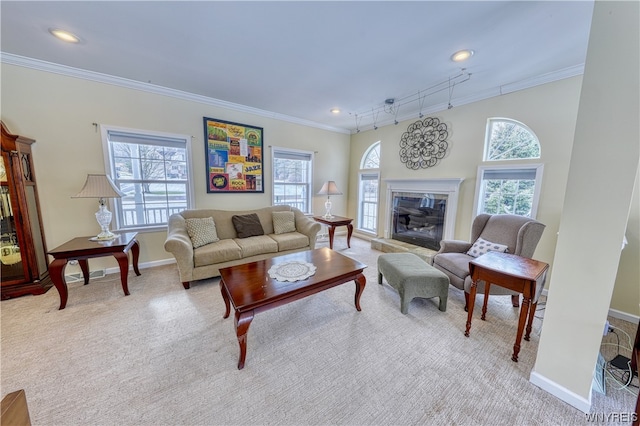 living room featuring ornamental molding, track lighting, and light colored carpet