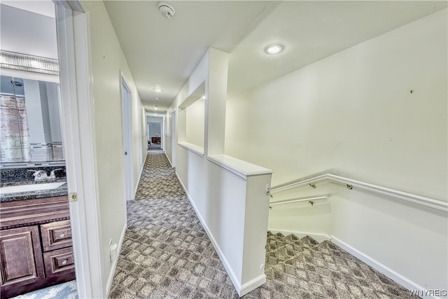 hallway with sink and carpet