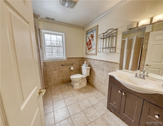 bathroom featuring vanity, tile flooring, toilet, and tile walls