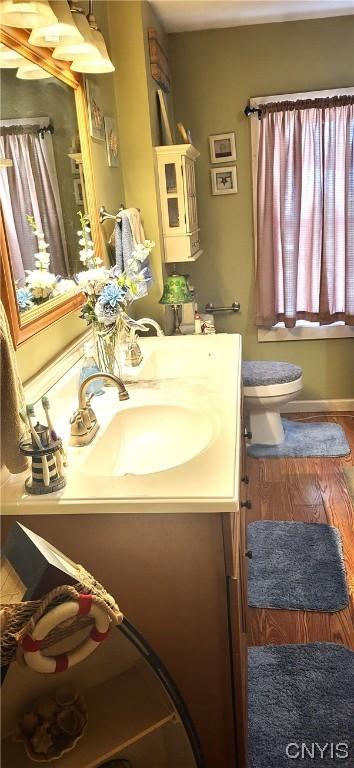 bathroom featuring hardwood / wood-style flooring, vanity, and toilet