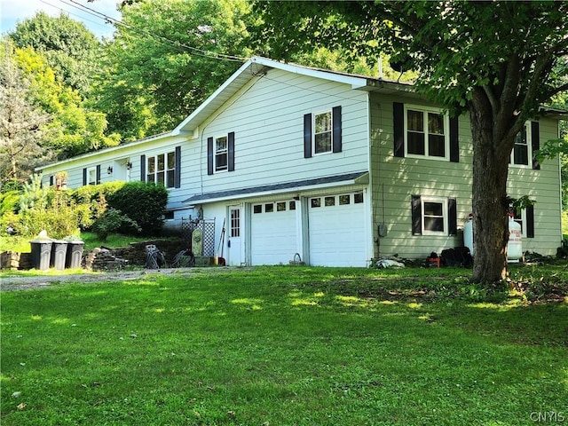 view of front facade with a garage and a front lawn