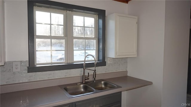 kitchen featuring sink, white cabinets, and a healthy amount of sunlight