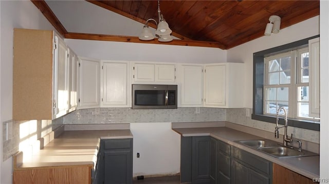 kitchen featuring white cabinetry, sink, and a wealth of natural light