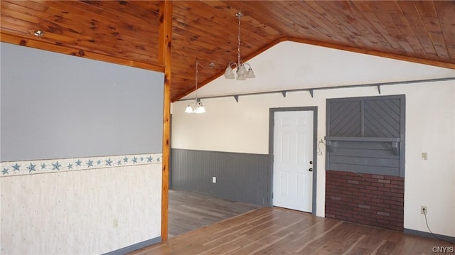 unfurnished room with dark wood-type flooring, wooden ceiling, lofted ceiling, and a notable chandelier