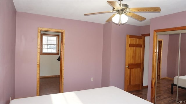 bedroom featuring ceiling fan, dark wood-type flooring, and a closet