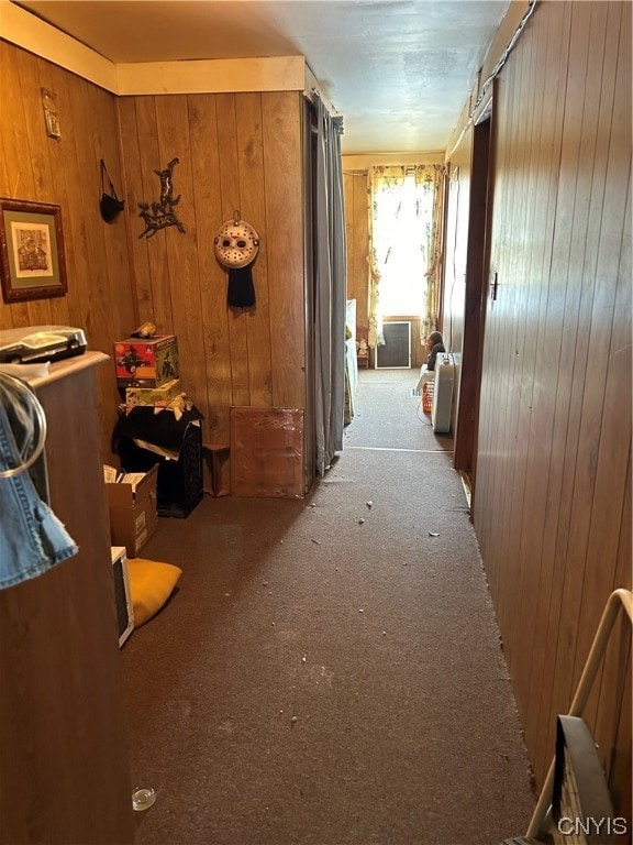 corridor with wooden walls and dark carpet