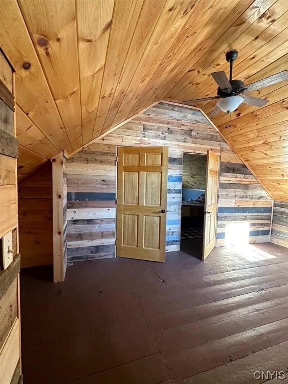 additional living space with wood ceiling, dark hardwood / wood-style floors, vaulted ceiling, and wooden walls