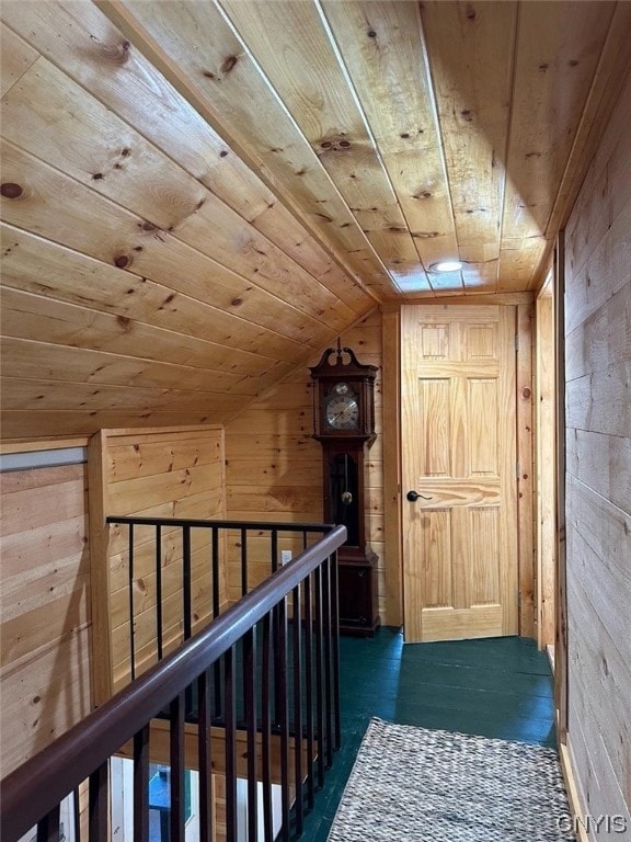 hallway with wooden ceiling, wood walls, vaulted ceiling, and dark hardwood / wood-style flooring