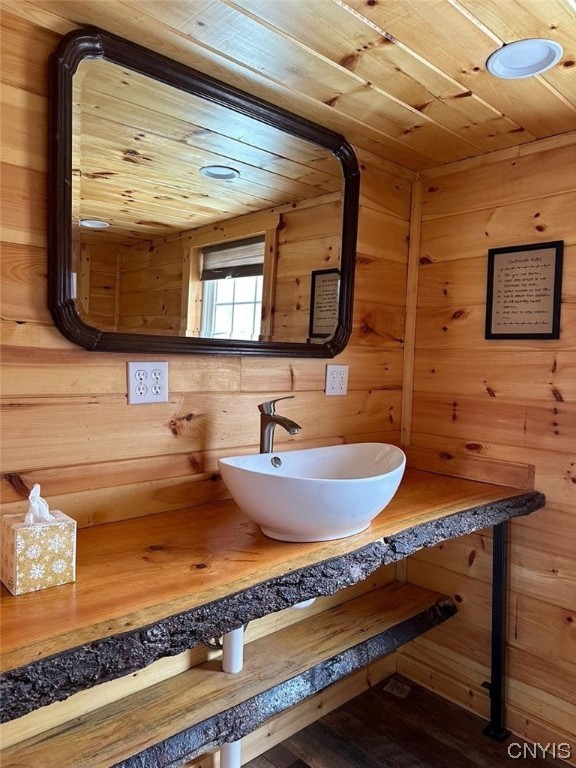 bathroom featuring wood ceiling, wood walls, vanity, and hardwood / wood-style flooring