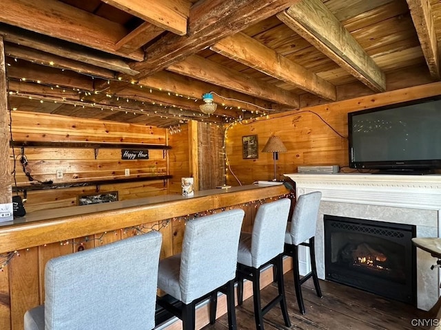 bar featuring wood walls, dark hardwood / wood-style floors, and wood ceiling