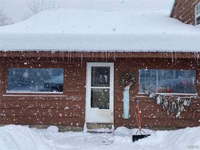 view of snow covered property entrance