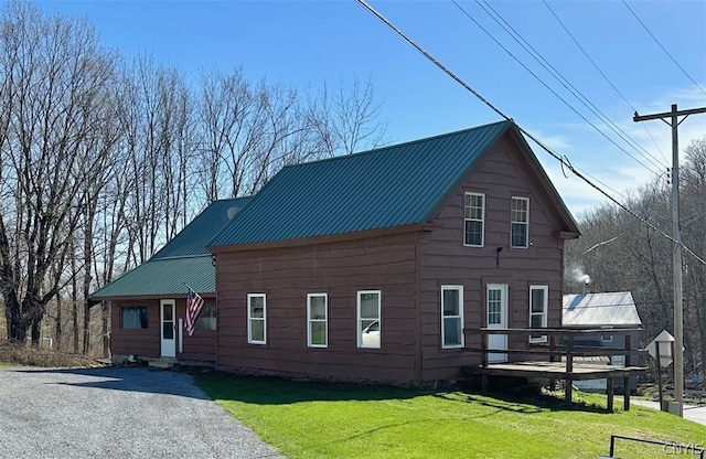 view of front of home featuring a deck and a front lawn