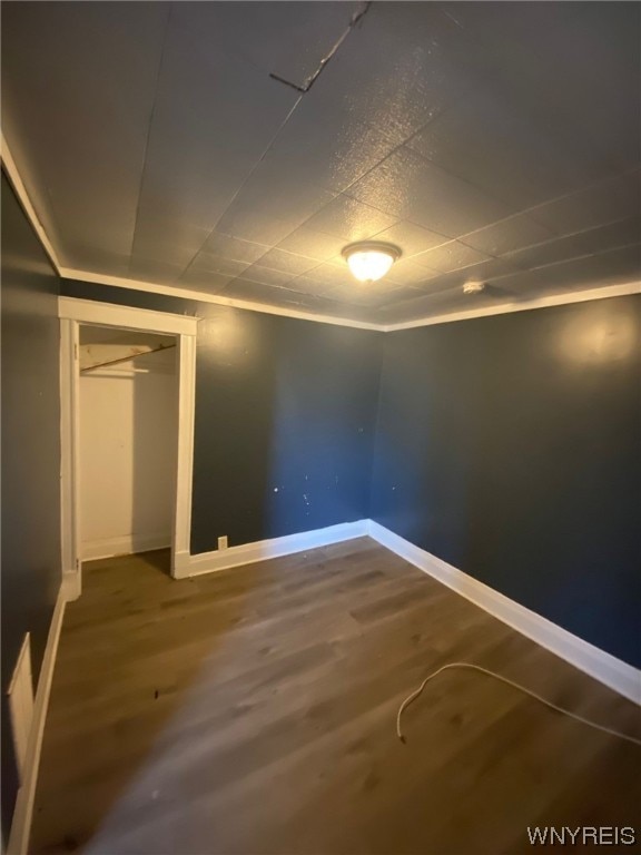 unfurnished bedroom featuring a closet and hardwood / wood-style flooring