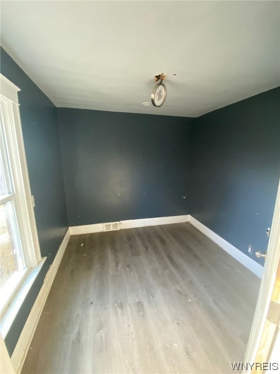 spare room with dark wood-type flooring