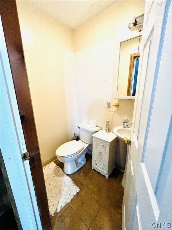 bathroom with toilet and tile patterned floors