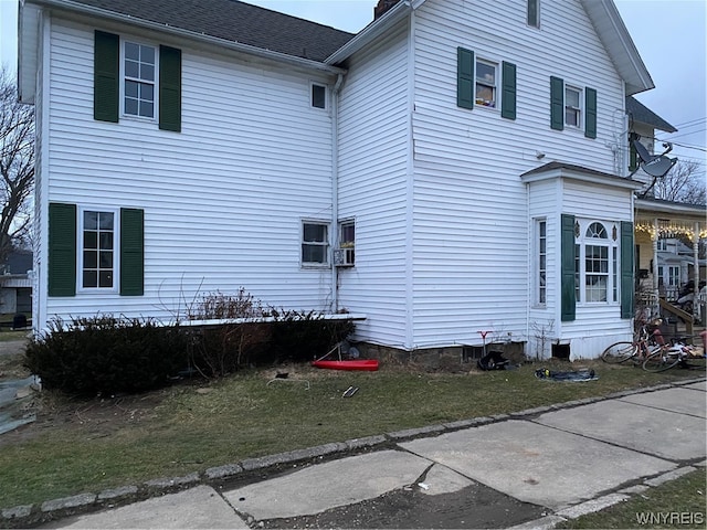 view of side of home with a lawn