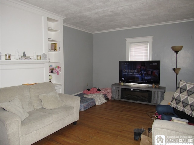 living room featuring dark hardwood / wood-style flooring, crown molding, and a textured ceiling