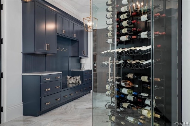 wine cellar featuring ornamental molding and light tile floors