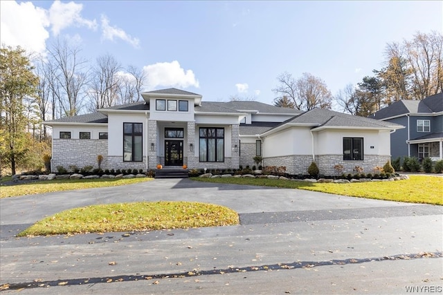 prairie-style house featuring a front lawn