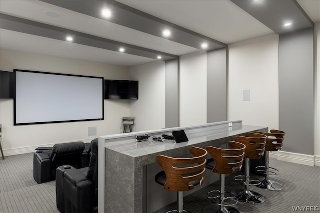 home theater with bar area and light colored carpet