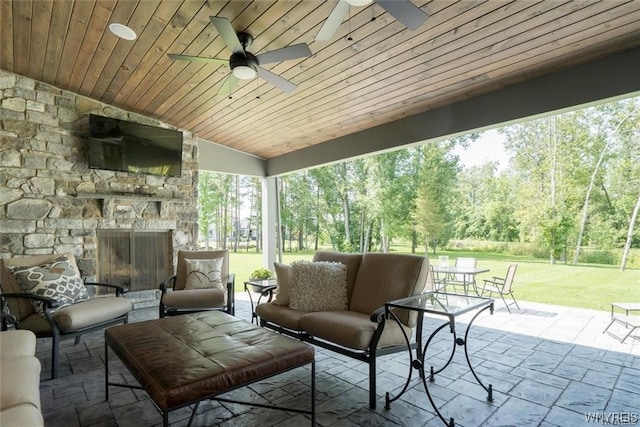 view of terrace featuring an outdoor living space with a fireplace and ceiling fan